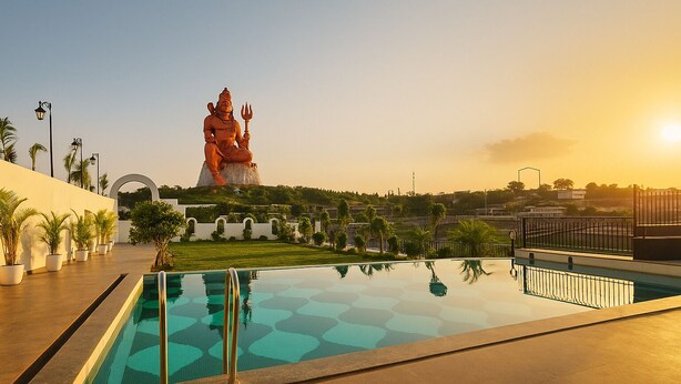 En swimmingpool med en staty i bakgrunden.