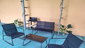 An outdoor patio with a sofa, two chairs, and a small table. - Apartmány ŠTĚSTÍ (Bechlin)