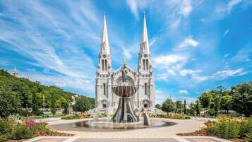A grand cathedral with twin spires and a central fountain.