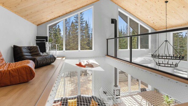 Un loft espacioso con techos altos, ventanas amplias, un nivel entre piso y un diseño de interiores moderno.