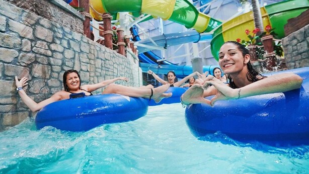 A water park with inflatable tubes and a water slide.