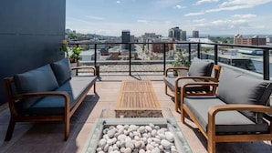 A rooftop terrace with outdoor seating, a fire pit, and a city view. - The 708 | For 4 People | Free Parking | BBQ (Québec)