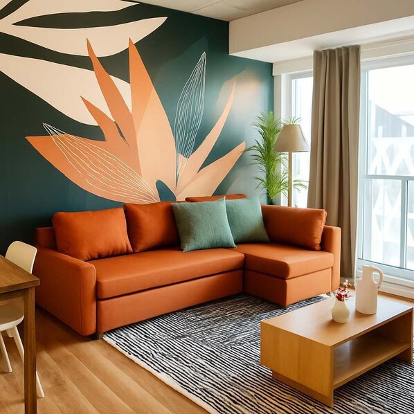 A modern living room with a sectional sofa, a coffee table, and a large abstract wall mural.