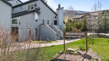 A residential building with a sign reading "MEADOWYLAK 3020 VILLAGE DRIVE".
