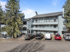 A multi-story parking garage with several cars and a bicycle. - Relaxed 1BR Mountain Escape | Fireplace & Parking (Steamboat Springs)