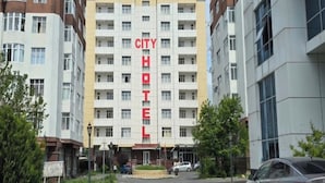 A CITY HOTEL building with multiple floors, a prominent sign, and a parking area in front. - Gabala City Hotel (Gabala)