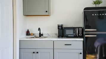 Fridge, microwave, coffee/tea maker, cookware/dishes/utensils