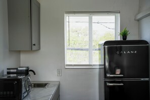 Fridge, microwave, coffee/tea maker, cookware/dishes/utensils