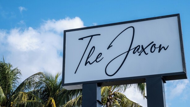 A sign with the text "The Jaxon" against a clear blue sky. - Comfort Living 2BR Deluxe Suite (West Palm Beach)