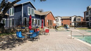 A poolside area with outdoor seating and a pool. - I012 - Upgraded 2BD | Pool | DFW South 183/161 (Irving)