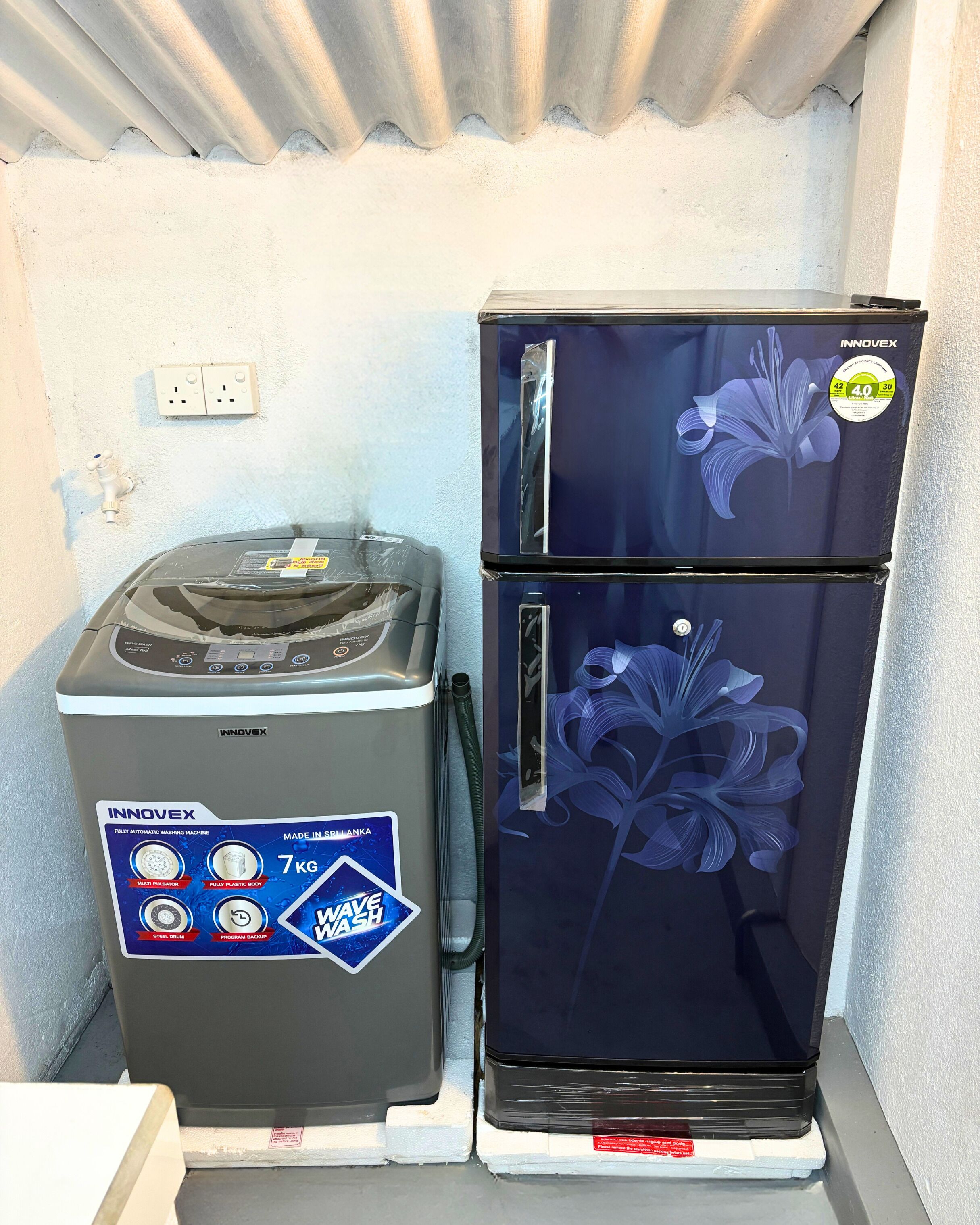 A washing machine and a refrigerator placed next to each other.