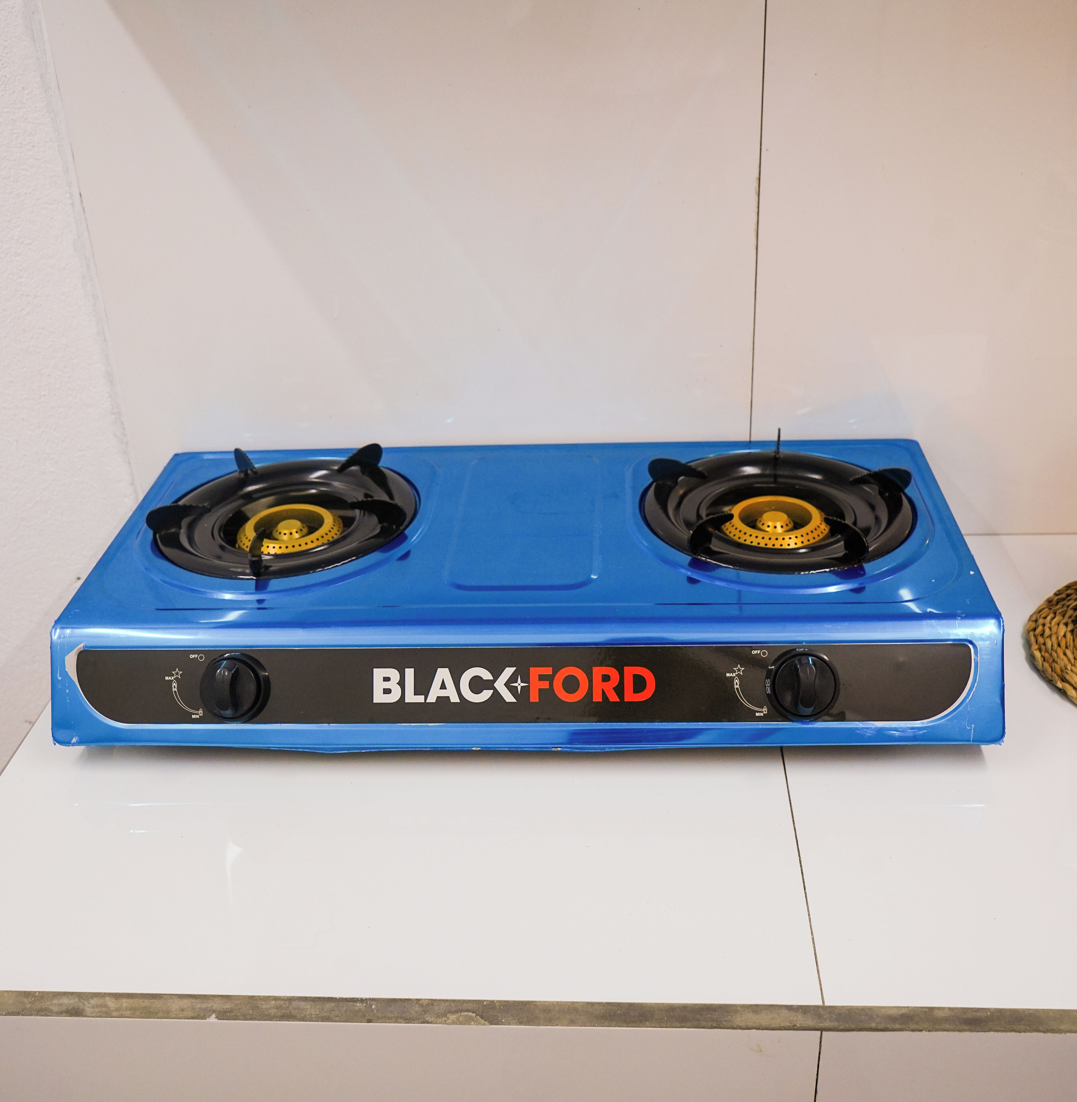 A blue Black+Ford stove with two burners and control knobs.