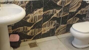 Separate bathtub and shower, towels, soap, shampoo