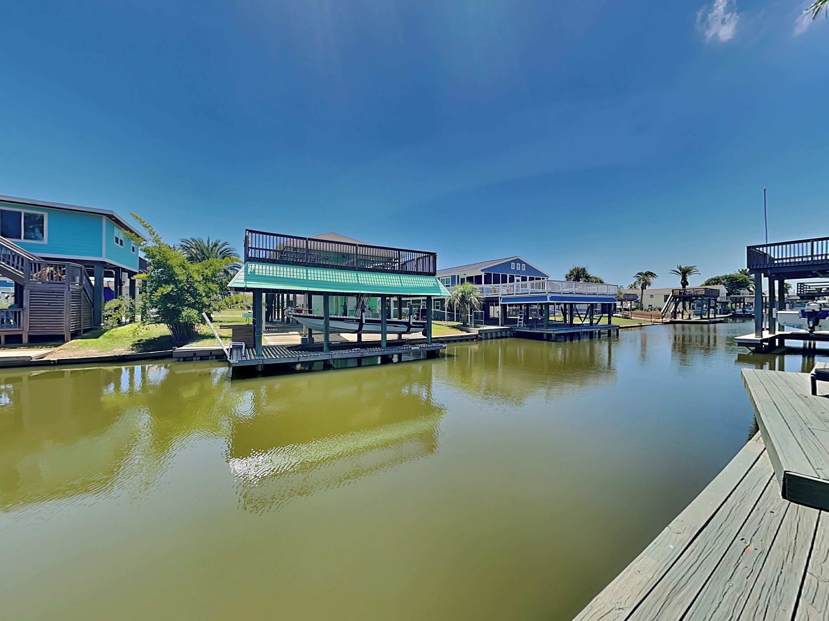 A waterfront property with multiple dock structures and buildings.