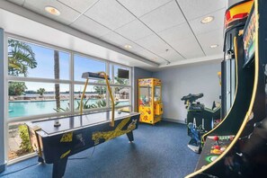 A pool table, arcade machines, and a view of a pool outside. - Lake View-Renovated -6 Miles to Disney (Orlando)
