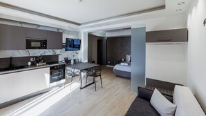 A modern kitchen with a dining area and a bedroom. - APARTMENT 1 (Misterbianco)