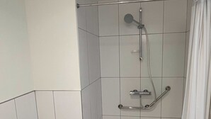 A shower area with a grab bar, a showerhead, and a curtain. - Comfort Studio in a Premium Residence- Sport/cinema (Huningue)