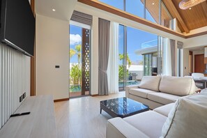 A modern living room with a sofa, a coffee table, and a TV.