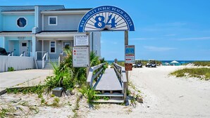 Una casa de playa con un cartel que indica el acceso público a la playa del condado.
