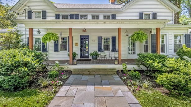 A two-story house with a front porch, a number '51' sign, and a well-maintained garden. - Beautiful 3-bedroom house in New Paltz with AC, WiFi, SunDeck & Close to ALL (New Paltz)