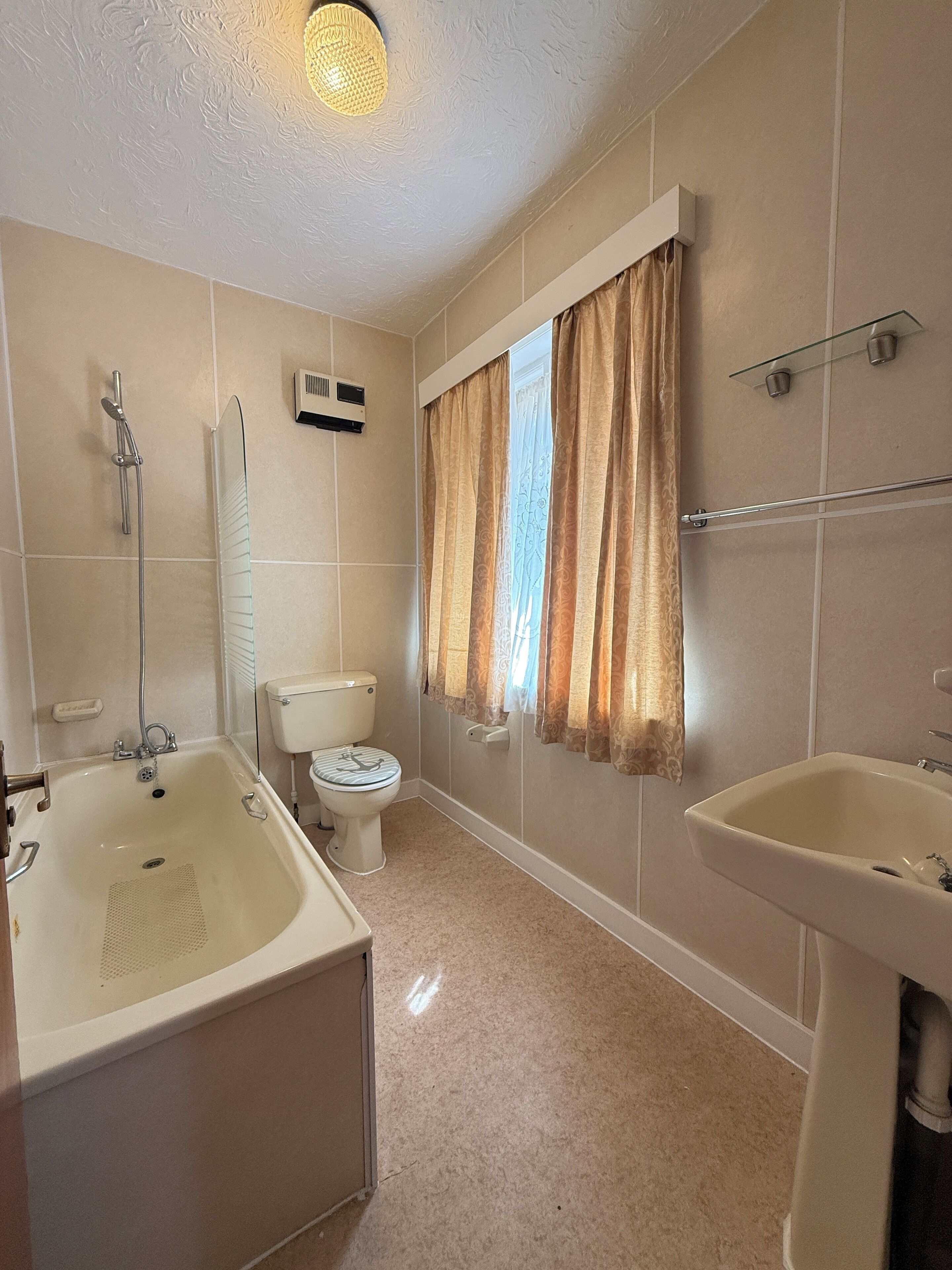 A bathroom with a bathtub, toilet, and sink.
