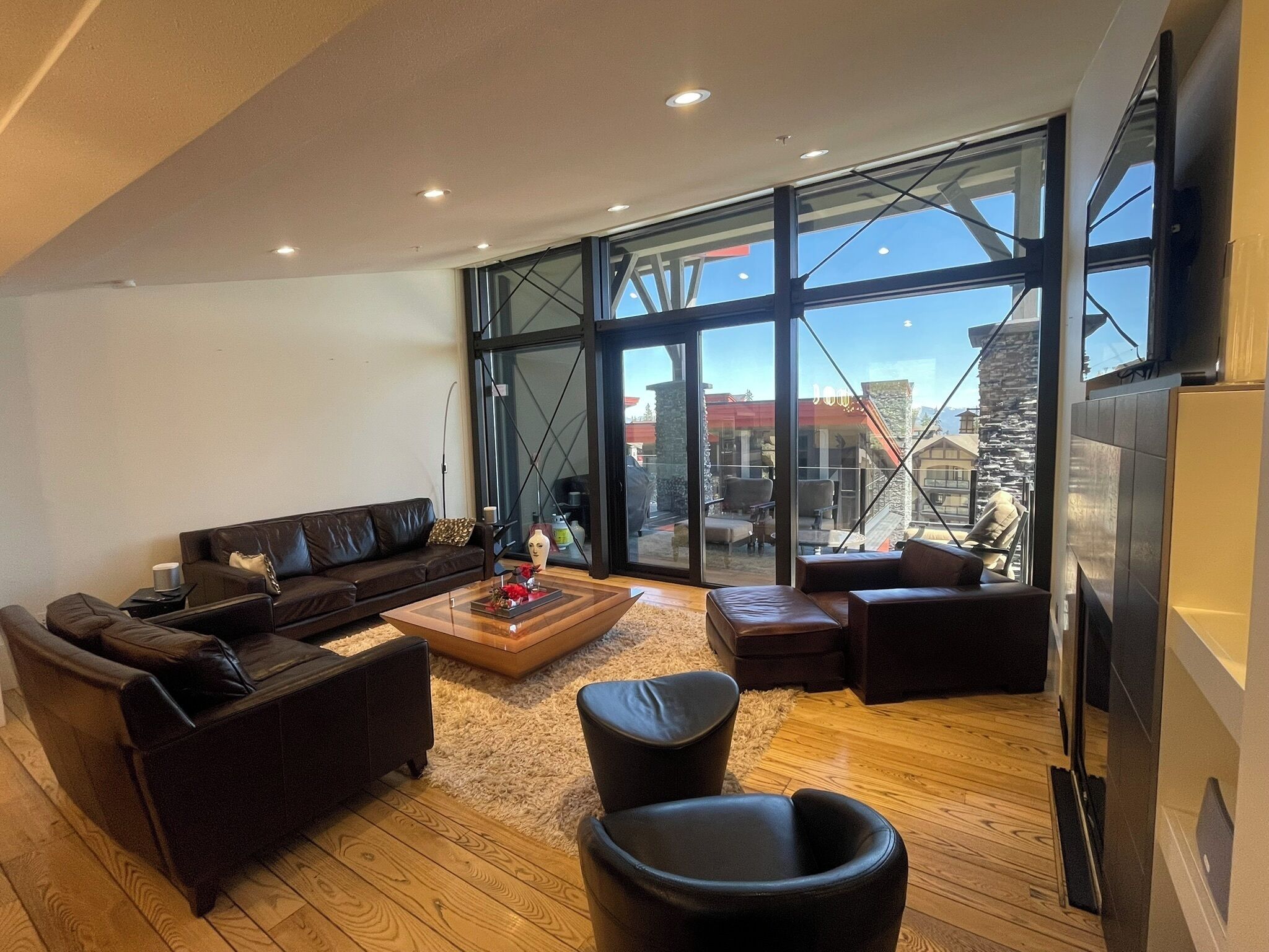 Living room has very comfortable seating with a large smart TV and cable