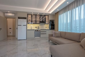 Deluxe Suite, Balcony, Pool View | Private kitchen | Fridge, microwave, oven, stovetop