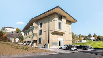 A modern building with a flat roof, large windows, and a flat facade.
