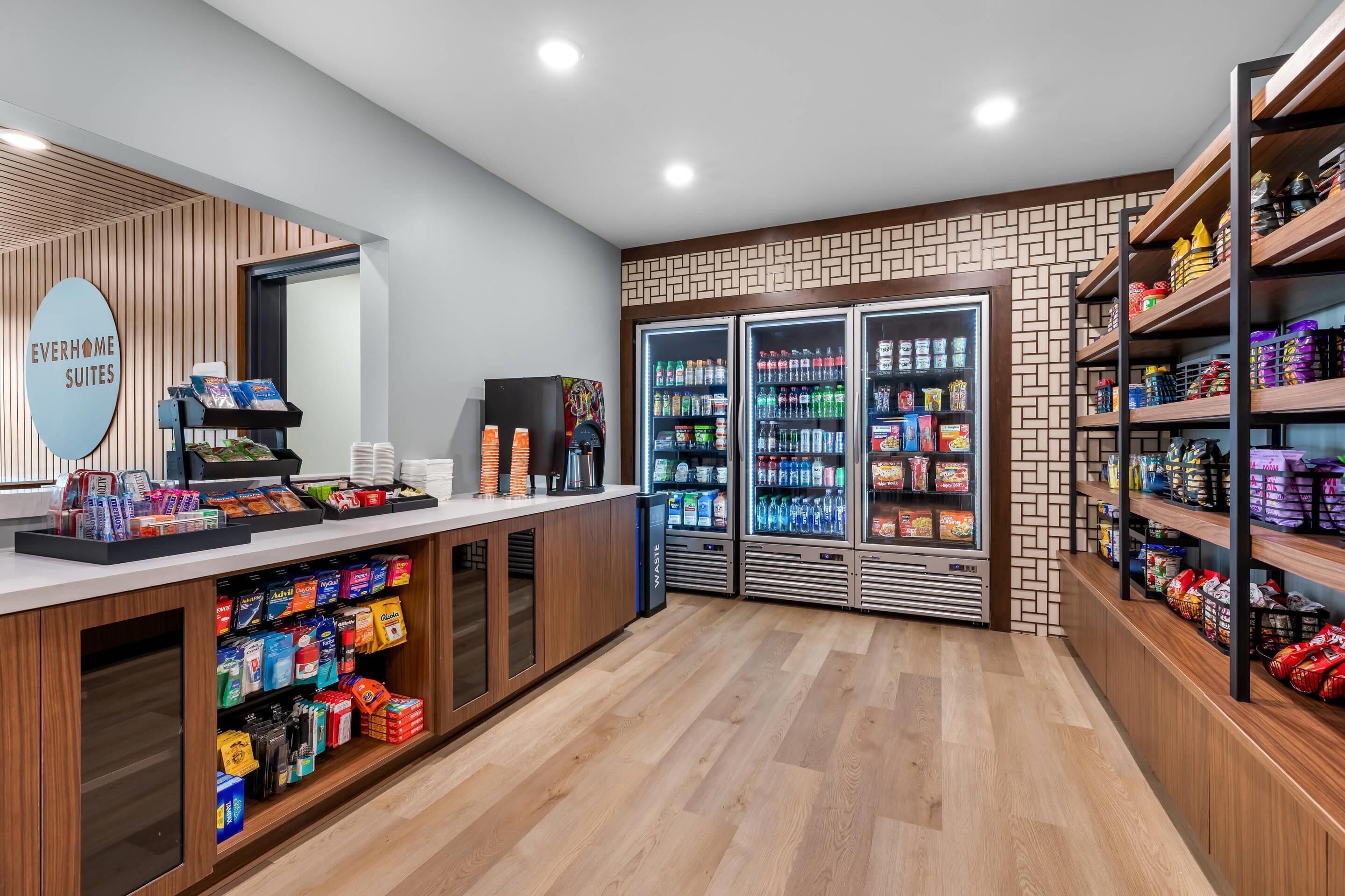 A reception area with a counter, vending machines, and refrigerated beverage dispensers.
