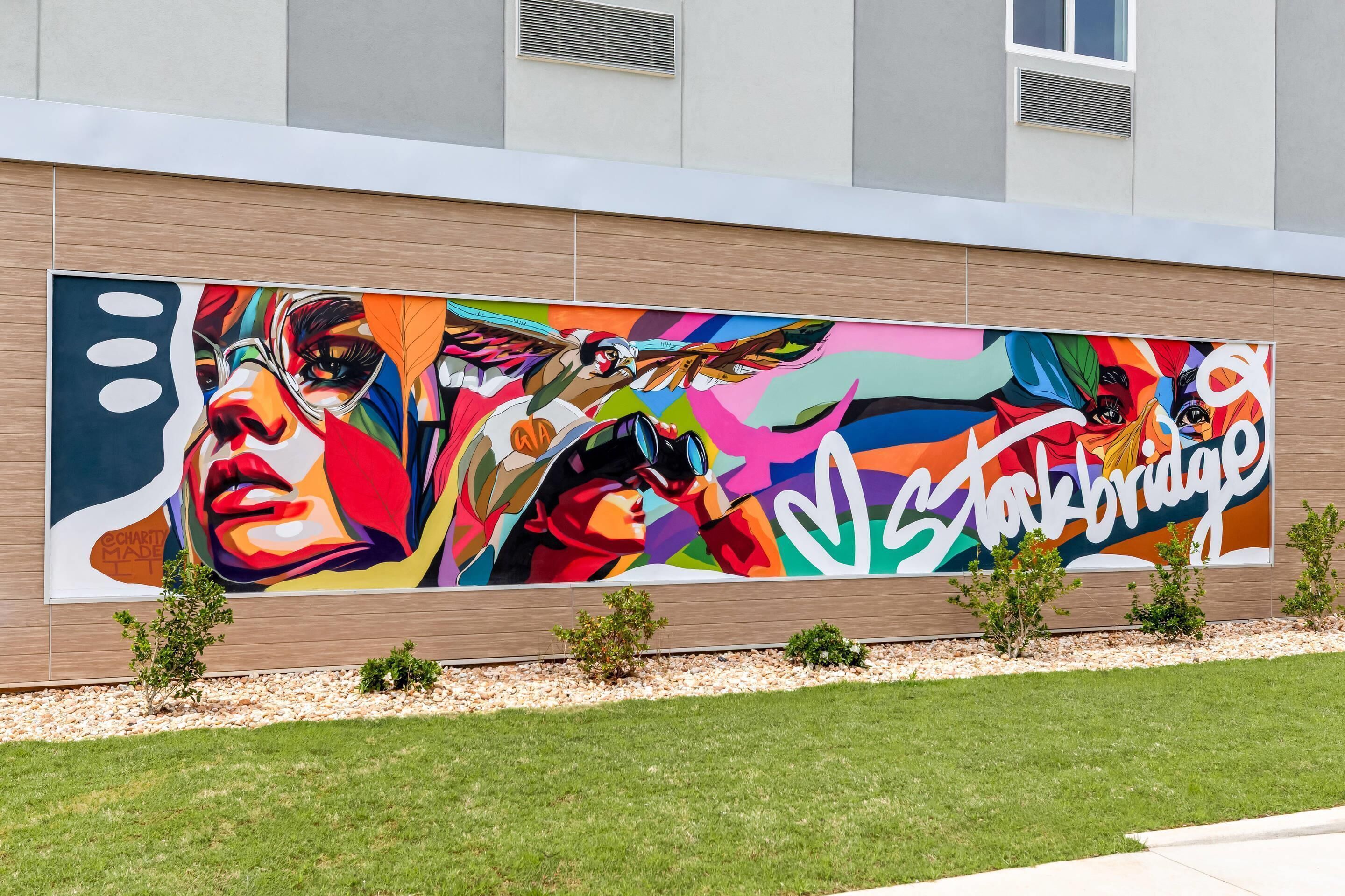 A large outdoor mural on a building's facade.