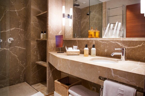A modern bathroom with a marble vanity, a large mirror, and a shower area. - Portixol Hotel & Restaurant (Palma de Mallorca)