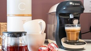 A coffee maker, a cup, a glass of coffee, and a tea container on a table. - B HOME STAY Blossom Lux Studio, Glasgow /  Airport (Paisley)