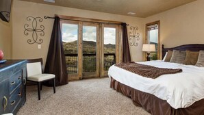 A bedroom with a large bed, a dresser, a chair, and a window with curtains. - Deer Valley  Lakeside Ski House *Sleeps 16 Free Ski Shuttle- Minutes to Deer Valley East Village and Jordanelle Reservoir (Heber City)
