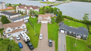 A residential area with houses, a river, and a highway.