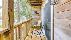 A wooden deck with two chairs and a decorative fish mounted on the wall. - Walk to Beach + Restaurants: Ocean City Getaway (Ocean City)