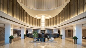 A modern lobby with a central reception desk, seating area, and a high ceiling with a circular light fixture. - Intercontinental Zhengzhou Zhengdong, by IHG (Zhengzhou)