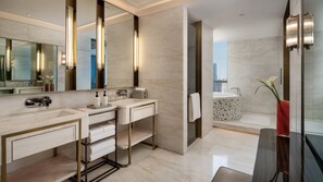 A modern bathroom with a large mirror, two sinks, a vanity, a towel rack, and a bathtub. - Intercontinental Zhengzhou Zhengdong, by IHG (Zhengzhou)