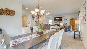 A spacious kitchen with a dining area, wooden cabinets, and a chandelier. - Waterfront Gem w/ Dock: 3 Mi to Fenwick Island Fun (Selbyville)