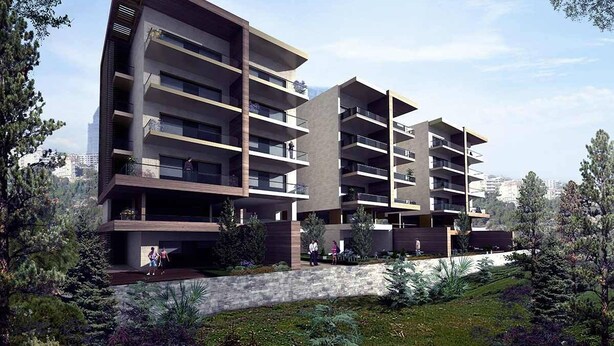 Un moderno edificio residencial de varios pisos con balcones, rodeado de vegetación y árboles.