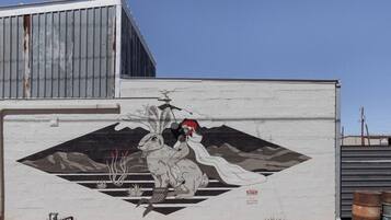 A mural of a woman and a rabbit on a building wall.