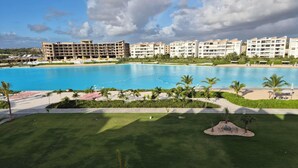 A resort with a large swimming pool, multiple hotel buildings, and well-maintained lawns.