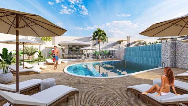 A pool area with lounge chairs, umbrellas, and a stone wall. - Stylish 1BR Flat Pool View & 10 min Walk to Beach (Avsallar)