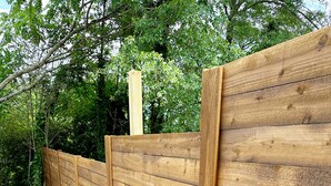A wooden fence in a garden area. - Newnan Gem (Newnan)