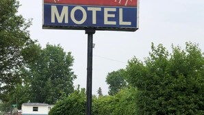 A motel sign with the name "Moon-Light Motel".