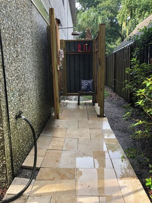 A pathway leading to a wooden gate with a digital display.