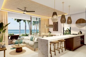 A modern living room with a large sofa, a dining table, and a kitchen area with bar stools. - Aytana Luxury Living (Progreso)