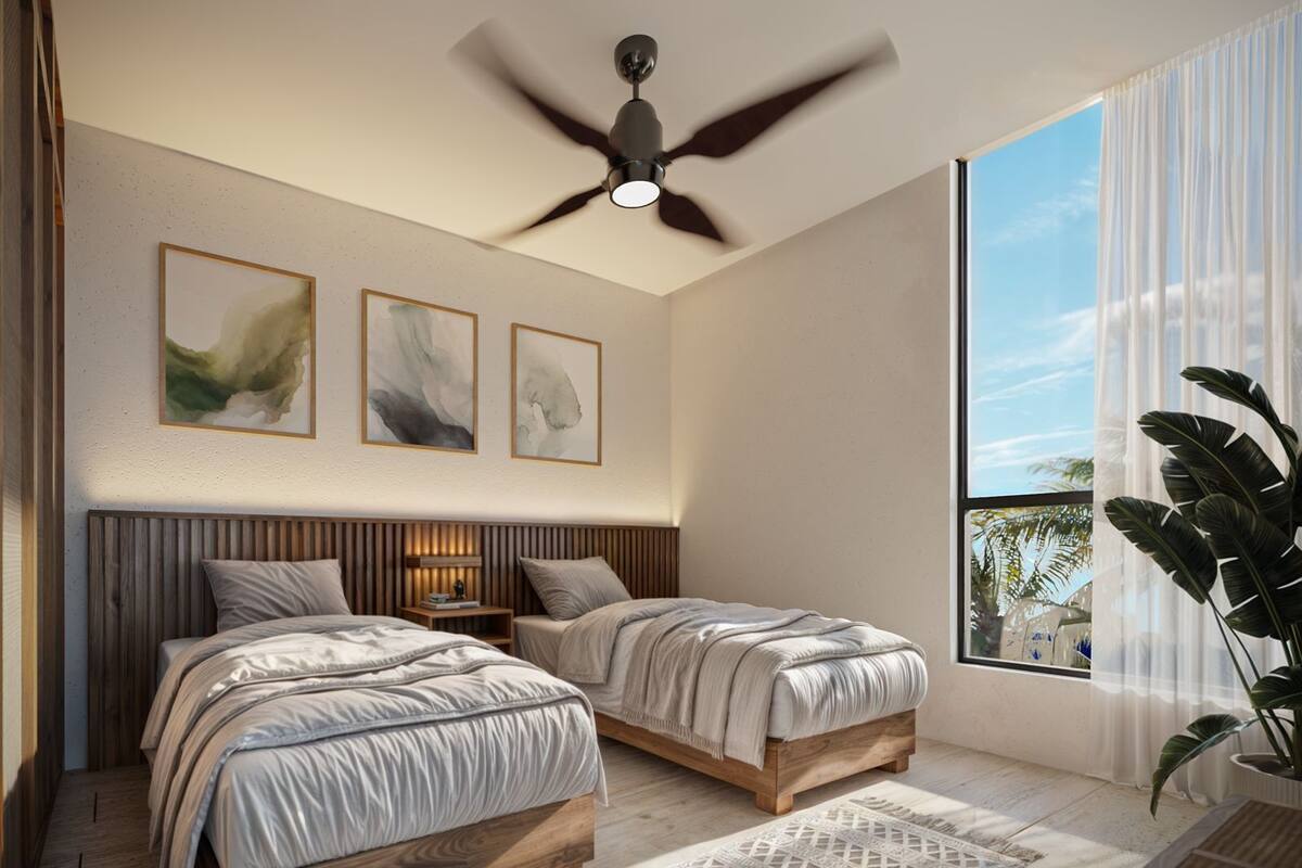 A modern bedroom with two beds, a ceiling fan, and large windows.