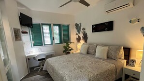 A bedroom with a bed, bedside tables, a desk, and a chair. - Romantic Beachfront Retreat - Everything You Want, In Las Terrenas - 2 Rooms (Las Terrenas)