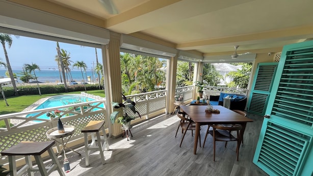 A covered outdoor area with a pool, wooden flooring, and a view of the ocean. - Romantic Beachfront Retreat - Everything You Want, In Las Terrenas - 2 Rooms (Las Terrenas)