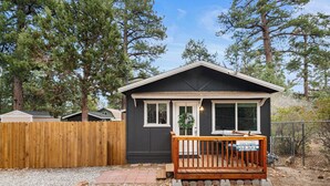 A small cabin with a wooden deck and a sign indicating "Cool Cabins." - The Maple Lane Hideaway (Sugarloaf)